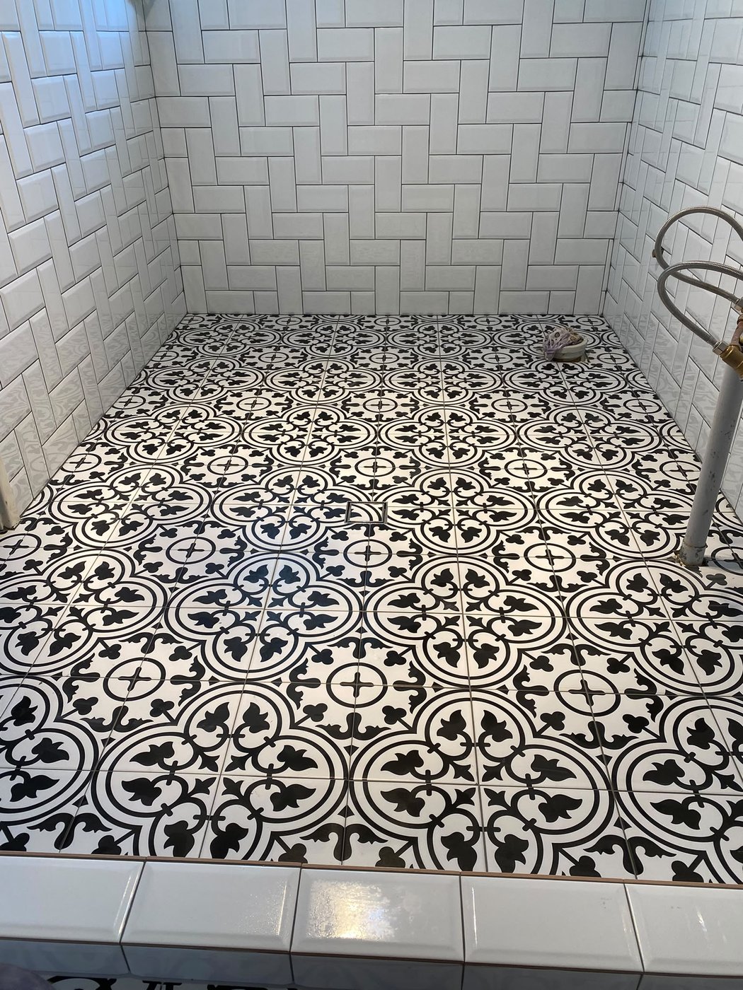 Black and white patterned encaustic feature floor in a Perth bathroom