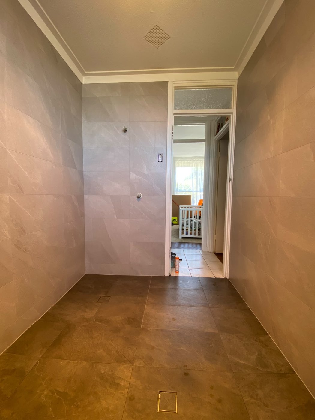 Stone-look large-format wall and floor tiling in a Perth bathroom